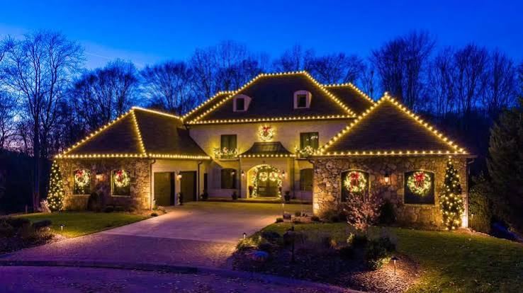 Large estate home with elaborate rooftop Christmas light installation