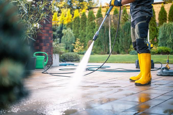 Pressure washing a concrete patio clean